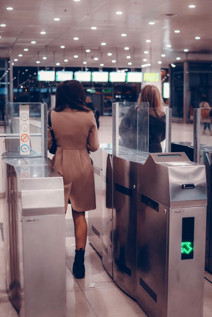 pexels photo 10640272 10640272 People passing through metro turnstile in modern station, showcasing travel infrastructure.